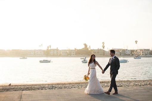 Bride and Groom holding hands on the sand at The Garty Pavilion.