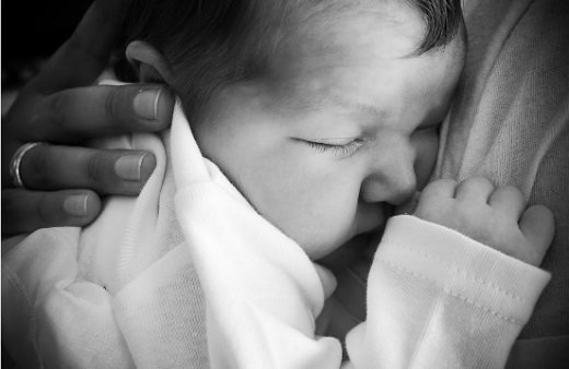 Baby wrapped in a blanket. Photo by Shirock Photography.