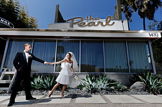 Newly married couple in front of The Pearl Hotel