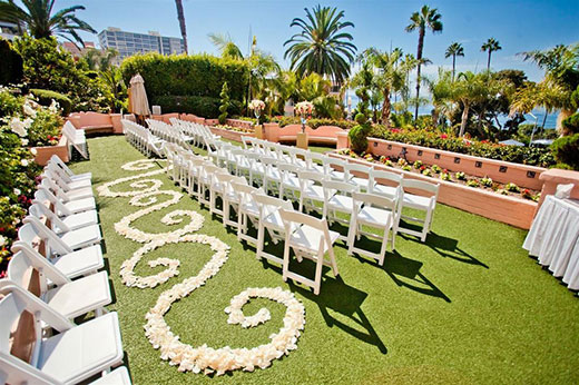 White seating over grass at La Valencia weddings