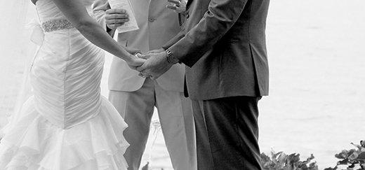Bride and Groom Holding Hands At Altar