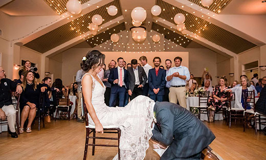 Groom Retrieving Garter From Bride