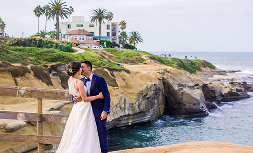 Groom and Bride Posing on Beach Cliff